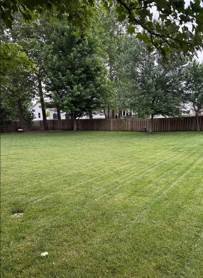 Striped backyard mowing work by C&B Mowing & More